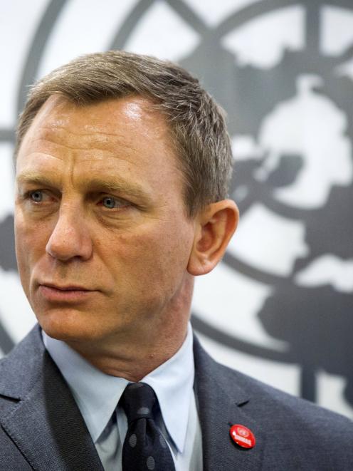 Actor Daniel Craig listens to speakers at a service designating him as the UN Global Advocate for...