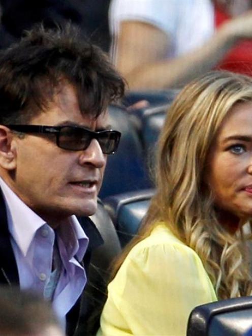 Actors Charlie Sheen and Denise Richards watch the New York Yankees take on the New York Mets at...