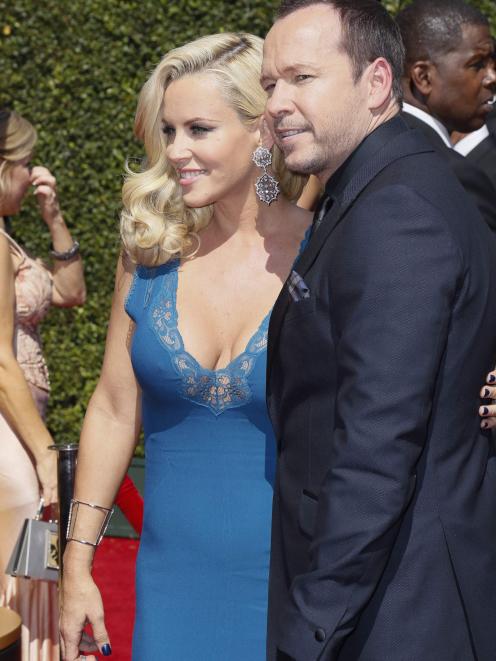 Actors Jenny McCarthy (L)and Donnie Wahlberg pose at the 2014 Creative Arts Emmy Awards in Los...