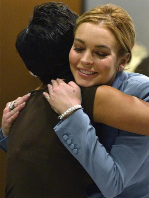 Actress Lindsay Lohan hugs her attorney Shawn Holley in this March file photo. REUTERS/Joe Klamar...