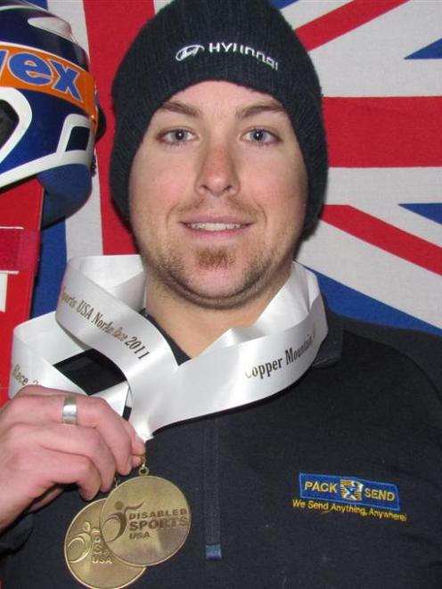 Adam Hall displays the medals he won in the standing slalom competition at the International...
