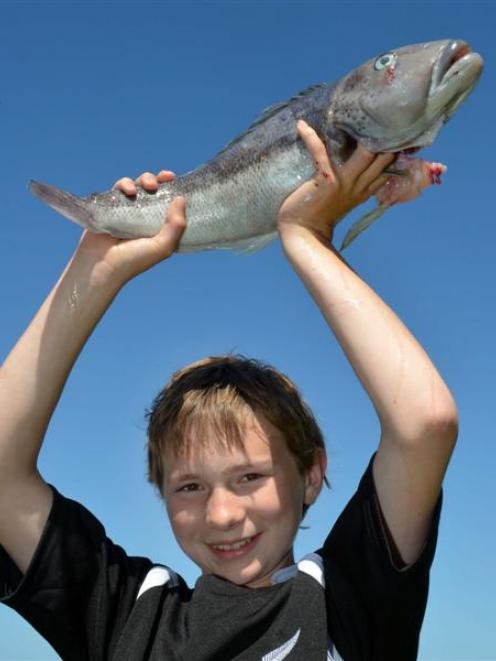 Adam Pullar (13) with a blue cod he caught despite ''getting seasick''. Photo by Stephen Jaquiery.