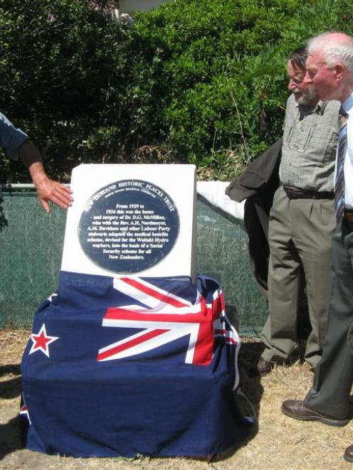 Admiring the new plaque outside the old doctor's residence in Kurow are, from left, Jim Meehan,...