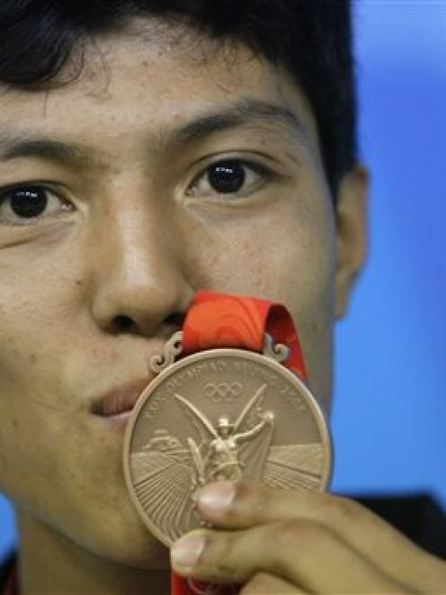 Afghanistan's Rohullah Nikpai attends a press conference with his bronze medal awarded n the men...
