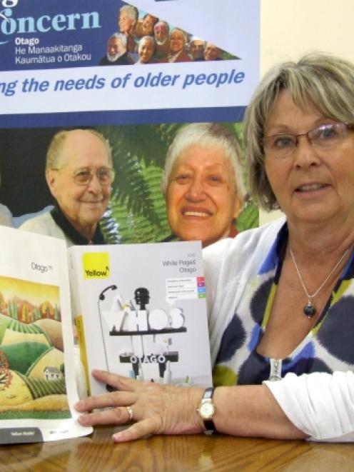 Age Concern Otago chief executive Susan Davidson compares the size of the old and new phone books...
