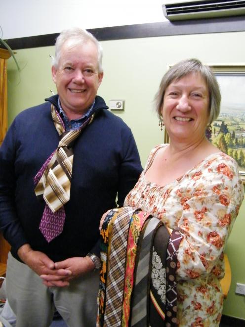 aimate Mayor Craig Rowley tries some ties on for size from Irene Sparks, who is aiming to set a...