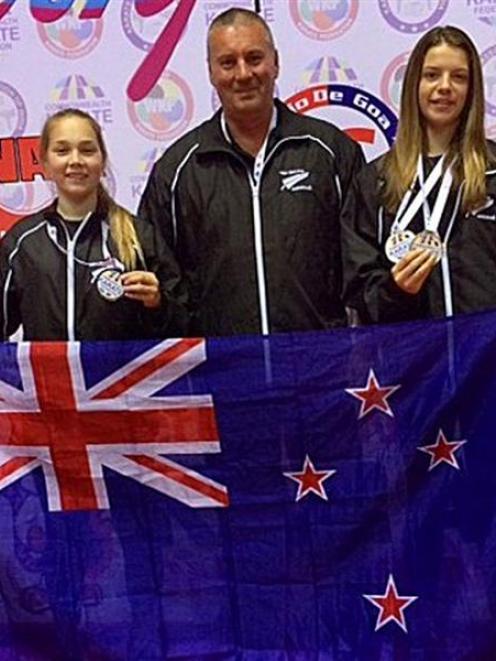 Aja Tate-Bell (13, left) of Alexandra,  and Holly Wigg (15), of Wanaka with their karate coach...