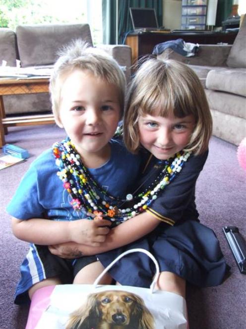 Albert Town Siblings Charlie and Emily Redwood wear some of the many strings of beads given to...