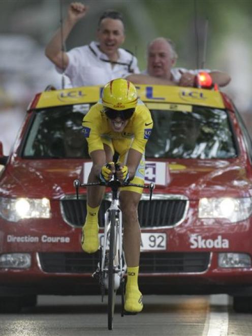Alberto Contador of Spain, wearing the overall leader's yellow jersey, crosses the finish line to...