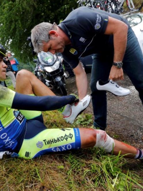 Alberto Contador receives medical assistance after crashing. REUTERS/Jean-Paul Pelissier