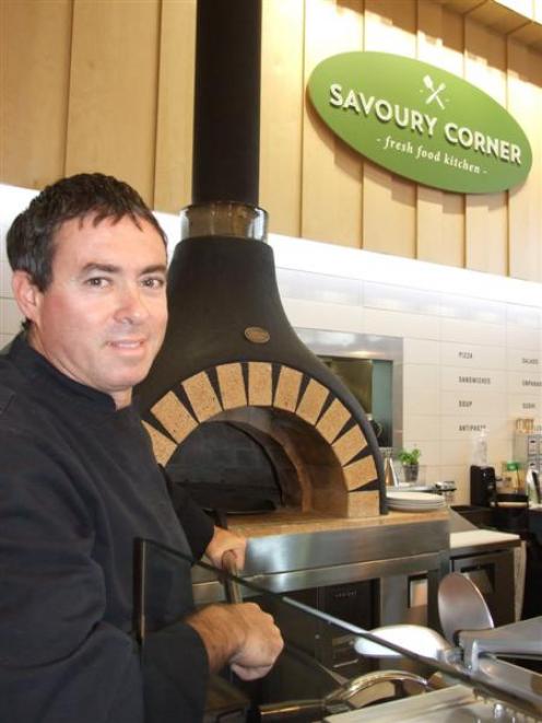 Alex Giminez, co-owner of Patagonia Chocolates and now Savoury Corner, with the new cafe's pizza...