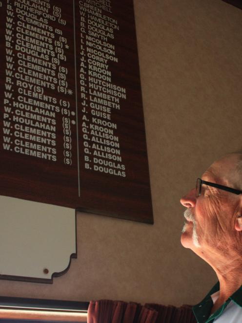 Alexandra bowler Bill Clements looks at his name repeated among a list of title winners at the...