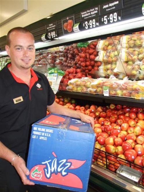 Alexandra New World produce manager Brent Omond with American-grown Jazz apples.  Photo by Lynda...