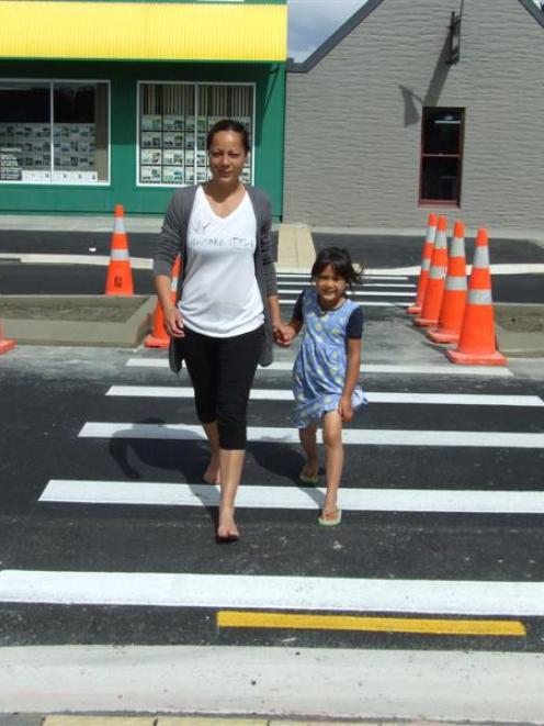 Alexandra residents Romaine Bright and daughter Anahera (4) use the new pedestrian crossing on...