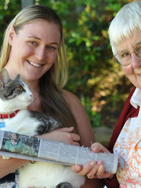 Alfie the cat with neighbour Sue Lloyd (right), whose newspaper he stole, and his owner Hayley...