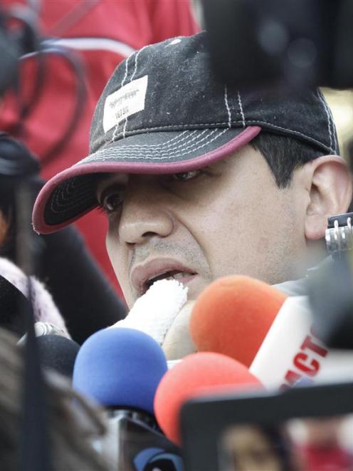 Alfonso Caballero, a Pemex employee injured in the blast, speaks to the media, after he leaves...