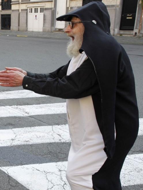 Alfred David (79), also known as "Monsieur Pingouin" (Mr. Penguin), goes for a walk dressed in...
