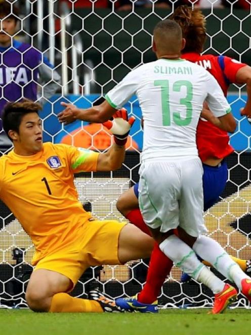 Algeria's Islam Slimani scores past South Korea's goalkeeper Jung Sung-ryong. REUTERS/Damir Sagolj