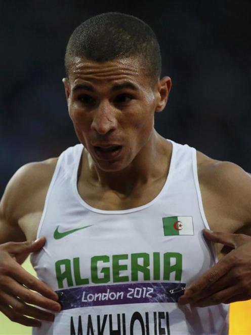 Algeria's Taoufik Makhloufi celebrates after finishing first in the men's 1500m semi-final. ...