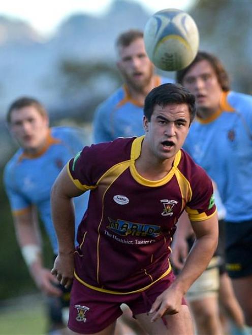 Alhambra-Union halfback Caleb Gray clears the ball in his side's premier match against University...