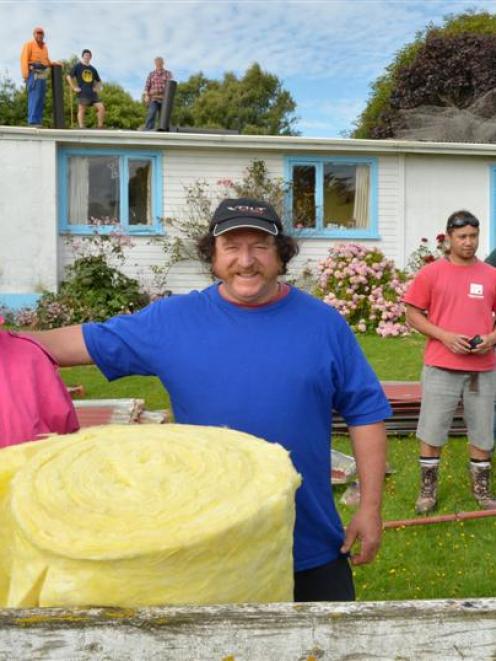 Alison and Peter Appleby (front), in front of their Waitati home, which was recently insulated ...