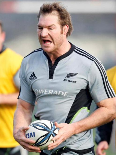 All Black Ali Williams winces in pain while running with the ball during a rugby training run...