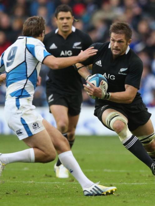 All Black captain Richie McCaw takes on Scotland's Mike Blair during the teams' test at...