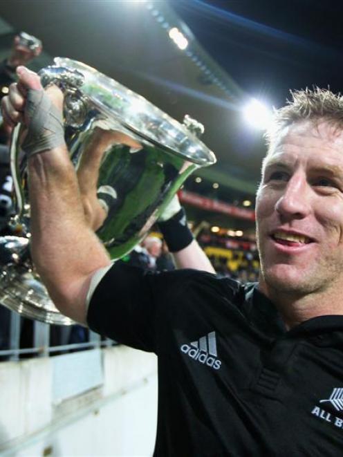 All Black lock Brad Thorn shows the Bledisloe Cup to the crowd after his side's win in the Tri...