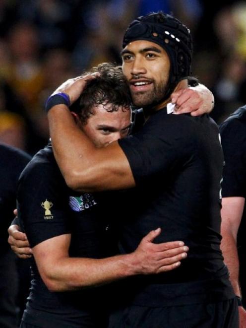 All Black loose forward Victor Vito (centre R) hugs Aaron Cruden after their Rugby World Cup...