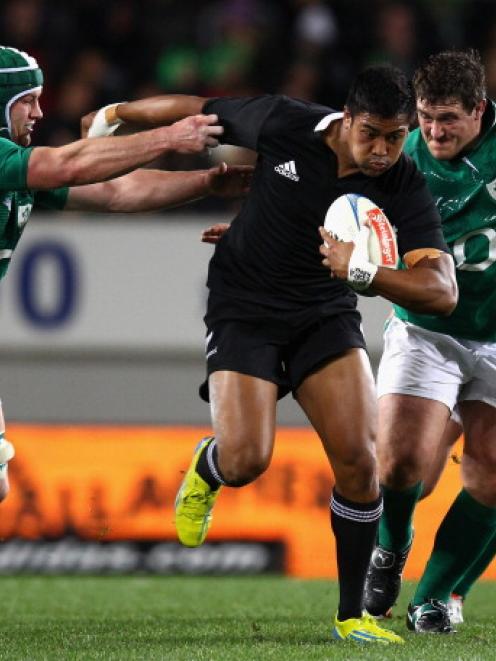 All Black winger Julian Savea bursts through the Ireland defence during their test at Eden Park...