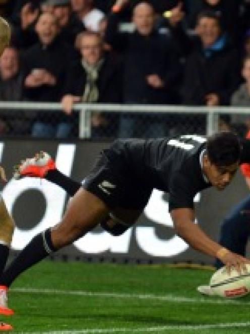 All Black winger Julian Savea scores in the corner. England fullback Mike Brown is too late,...