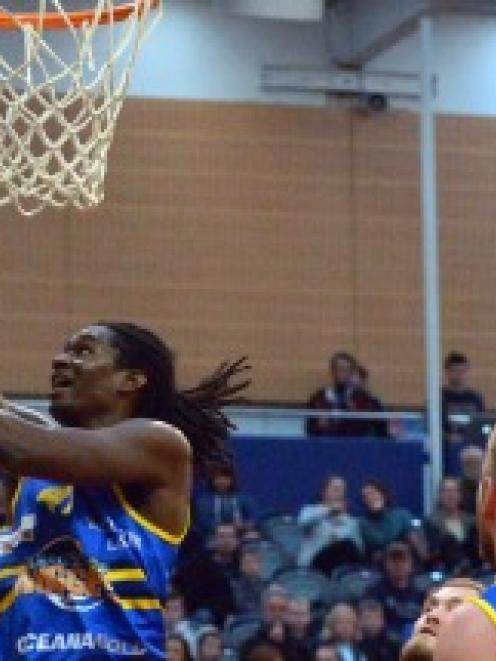 Warren Carter he finds the hoop during the Nuggets' match against the  Canterbury Rams at the...