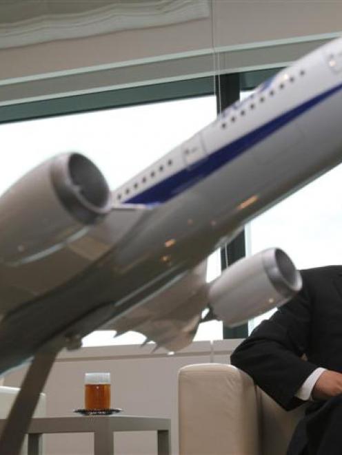 All Nippon Airways co-president Shinichiro Ito with a model of Boeing 787 Dreamliner aircraft....