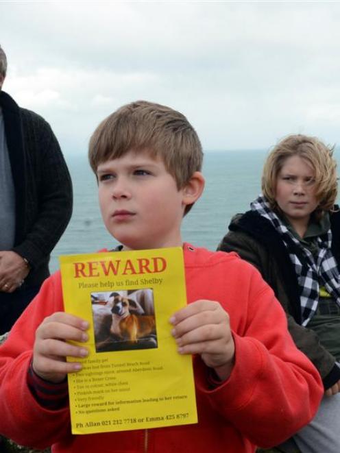 Allan Towers with sons Ethan (left) and Rueben pause during a search for their missing dog,...