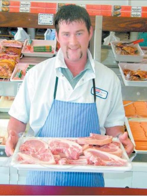 Alliance Group Butcher Shop manager Chris Duffy with a tray of pork chops, which are popular with...