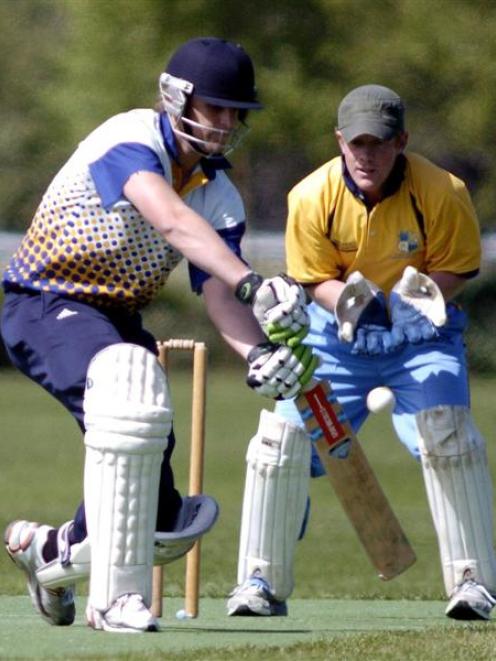 am Wells (Dunedin) chases a delivery as Otago Country wicketkeeper Scott Simpson looks on during...