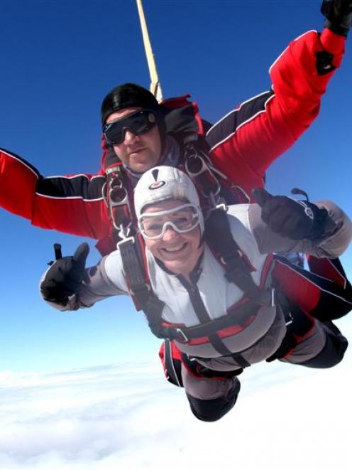 Amanda Burrows leaps from 15,000ft with NZone's Nick Dowling on Saturday afternoon to take the ...
