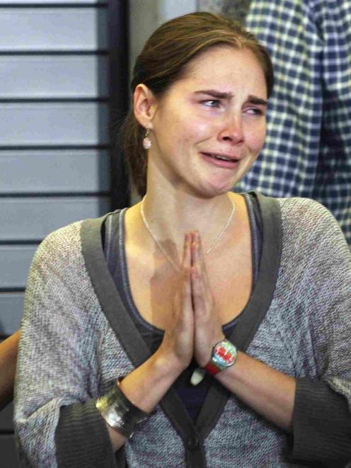 Amanda Knox cries and gestures to friends during a news conference at Sea-Tac International...