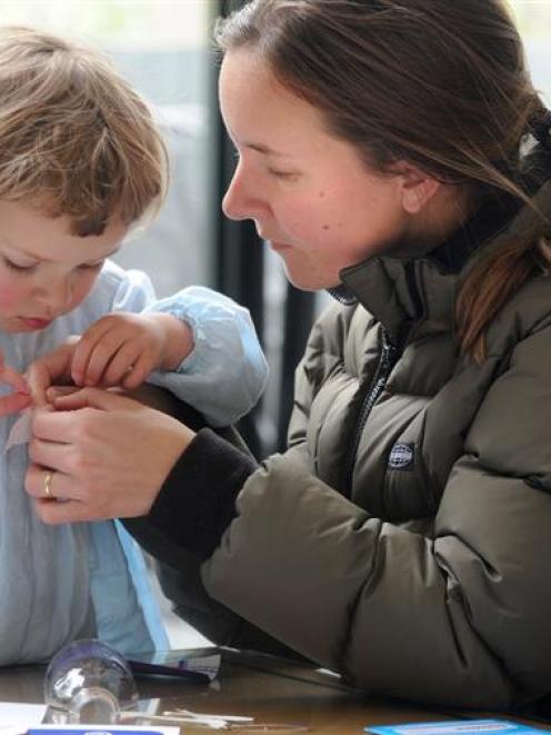 Amy Thorburn helps daughter Audrey (2) make a miniature steamship at the Swashbuckling Steamships...