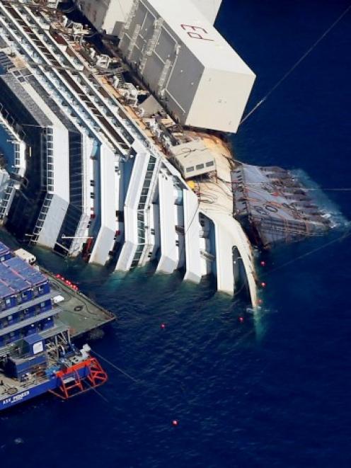 An aerial view shows the Costa Concordia lying on its side next to Giglio Island. REUTERS...