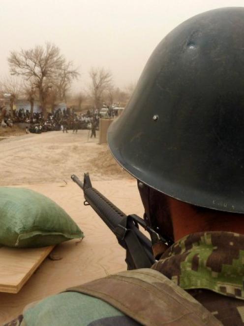 An Afghan National Army soldier keeps watch inside a US base in Panjwai district, Kandahar...