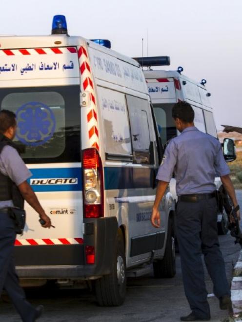 An ambulance carrying British tourists wounded during the hotel attack arrives at Monastir...