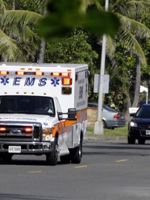 An ambulance leaves the area where President Barack Obama and his family is staying in Kailua,...