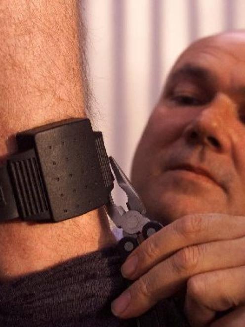 An anklet is fitted to a man sentenced to home detention. Photo by NZ Herald.