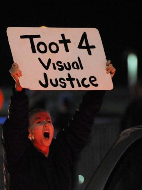 An anti-Wellywood sign protester at Wellington Airport last night. Credit:NZPA / Ross Setford.