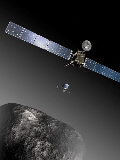An artist's impression shows the Rosetta orbiter deploying the Philae lander to comet 67P...