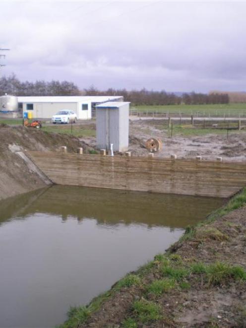 An effluent pond with weeping wall to separate liquid from solids. Photo from ORC.