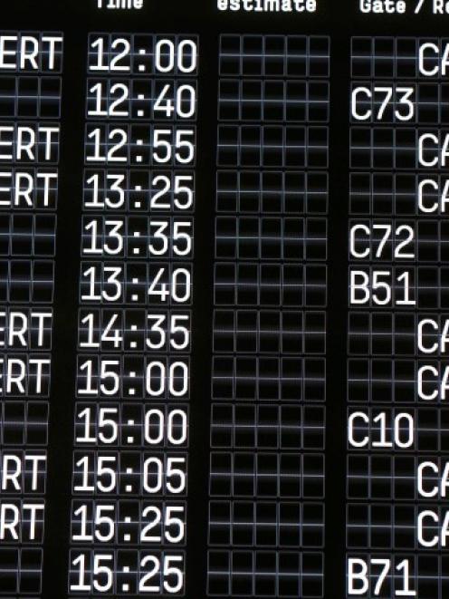 An electronic information board shows cancelled flights at Cologne-Bonn airport in Germany....