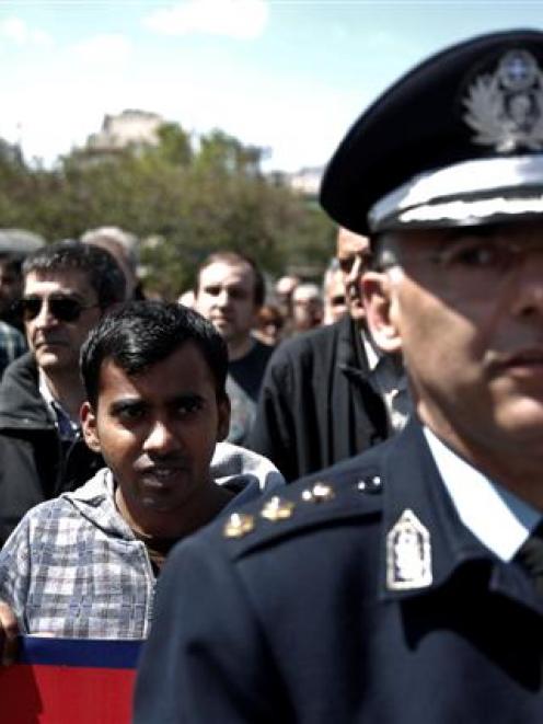 An immigrant who lives in Greece takes part in a rally protesting against a strawberry farm...