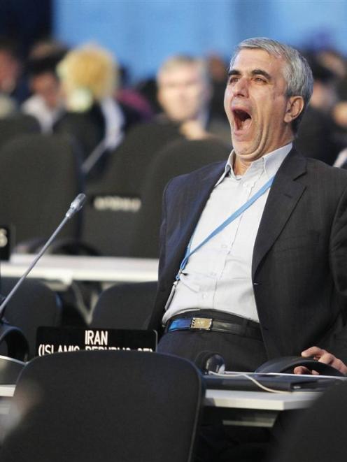 An Iranian delegate fights boredom during a plenary session of the UN Climate Change Conference ...